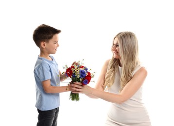 Photo of Little boy presenting bouquet of beautiful flowers to his smiling mother on white background