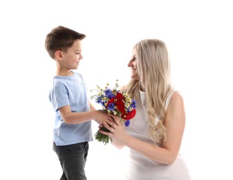 Photo of Little boy presenting bouquet of beautiful flowers to his smiling mother on white background