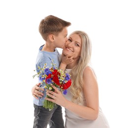 Photo of Little boy kissing his smiling mother with bouquet of beautiful flowers on white background
