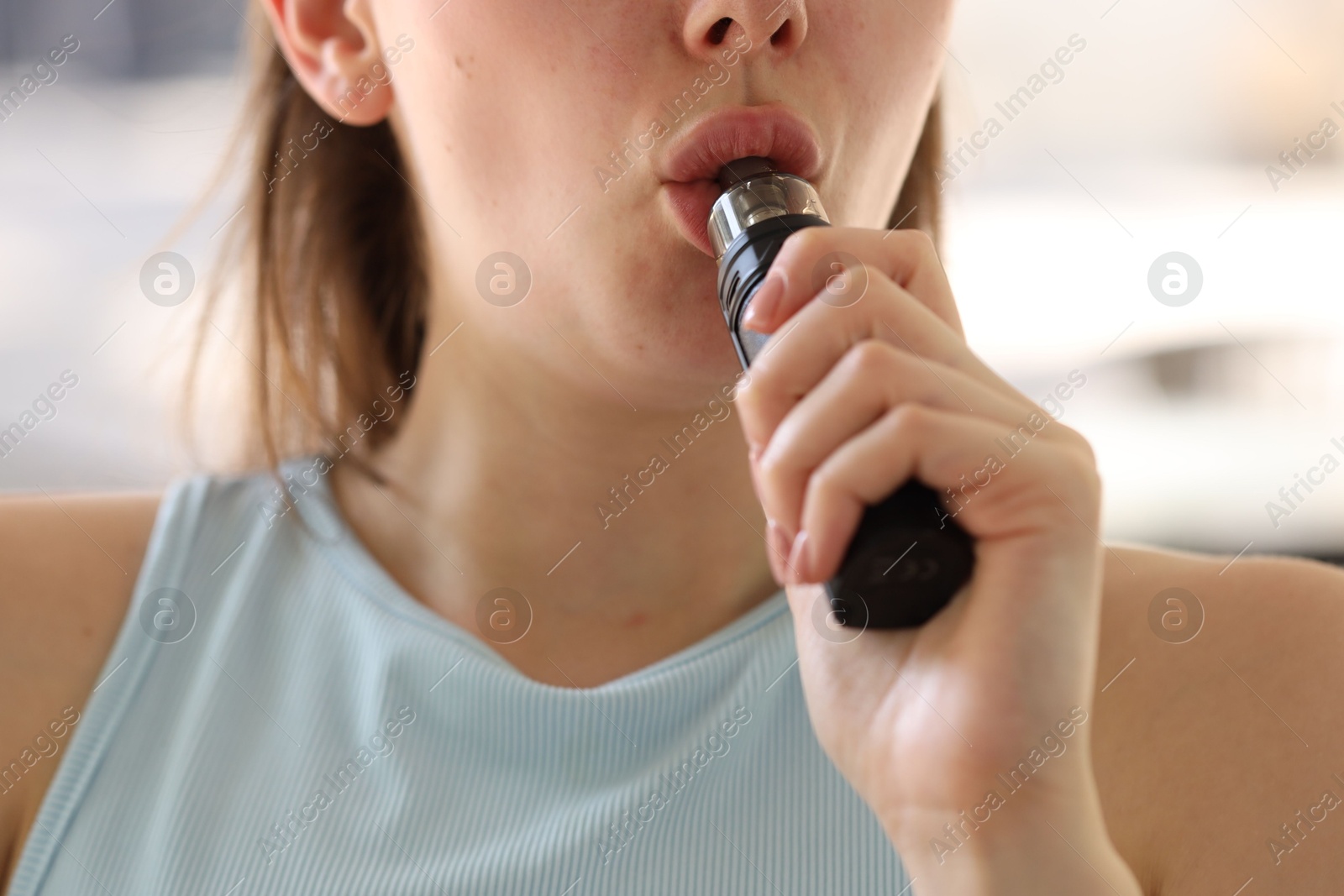 Young woman using electronic smoking device outdoors, closeup Photo of Young woman using electronic smoking device outdoors, closeup
