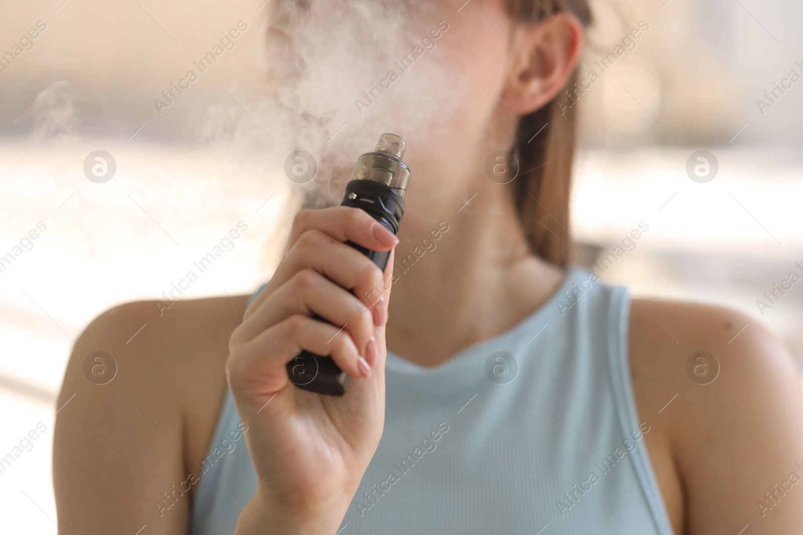 Young woman using electronic smoking device outdoors, closeup Photo of Young woman using electronic smoking device outdoors, closeup