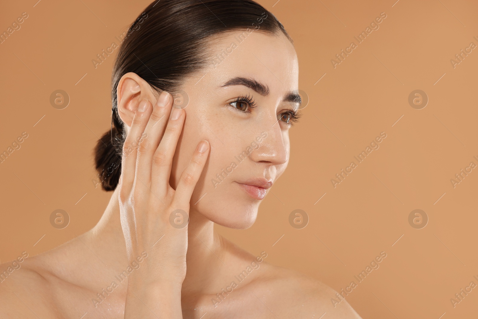Beautiful woman after spa treatment on beige background, closeup. Space for text Photo of Beautiful woman after spa treatment on beige background, closeup. Space for text