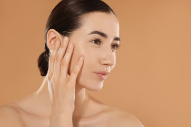 Photo of Beautiful woman after spa treatment on beige background, closeup. Space for text