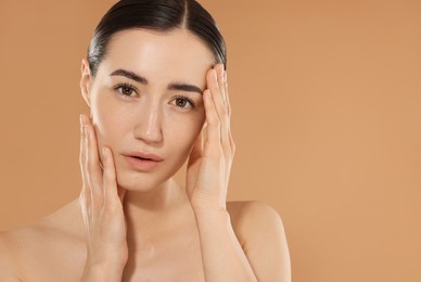 Photo of Beautiful woman after spa treatment on beige background, closeup. Space for text