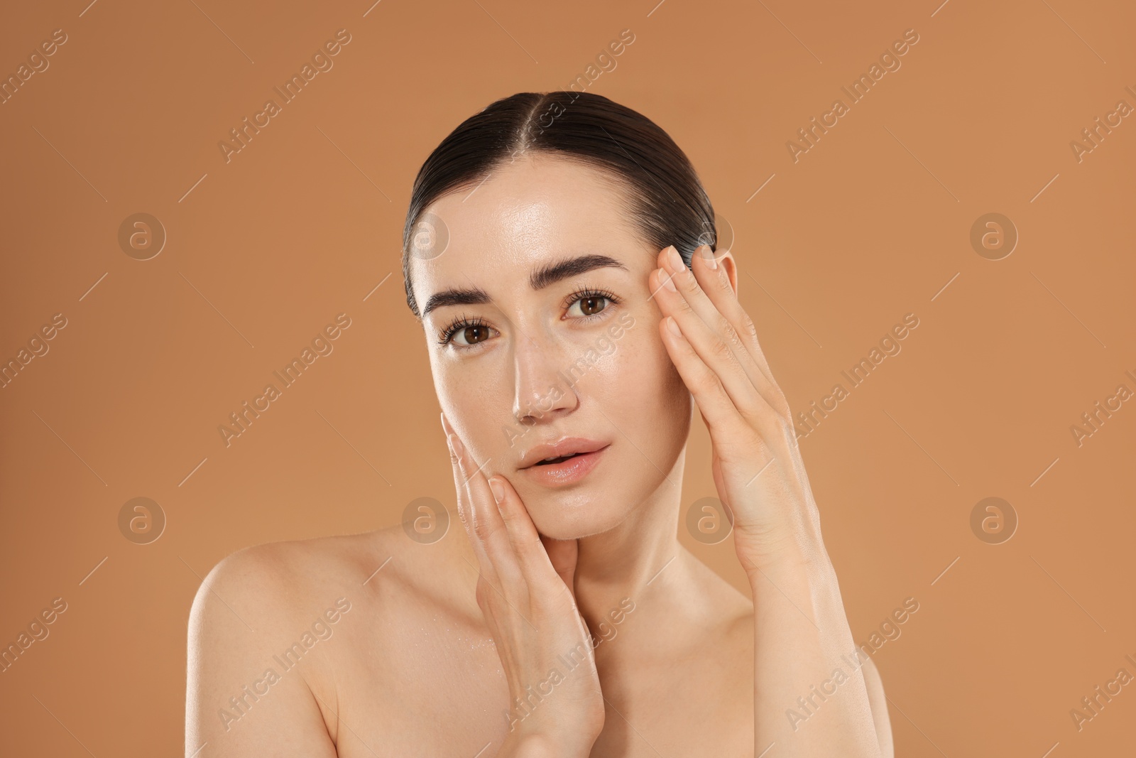 Beautiful woman after spa treatment on beige background Photo of Beautiful woman after spa treatment on beige background