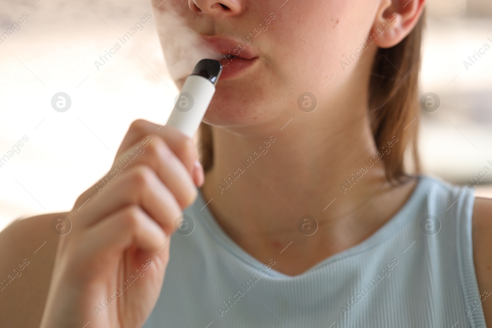 Young woman using electronic smoking device outdoors, closeup Photo of Young woman using electronic smoking device outdoors, closeup