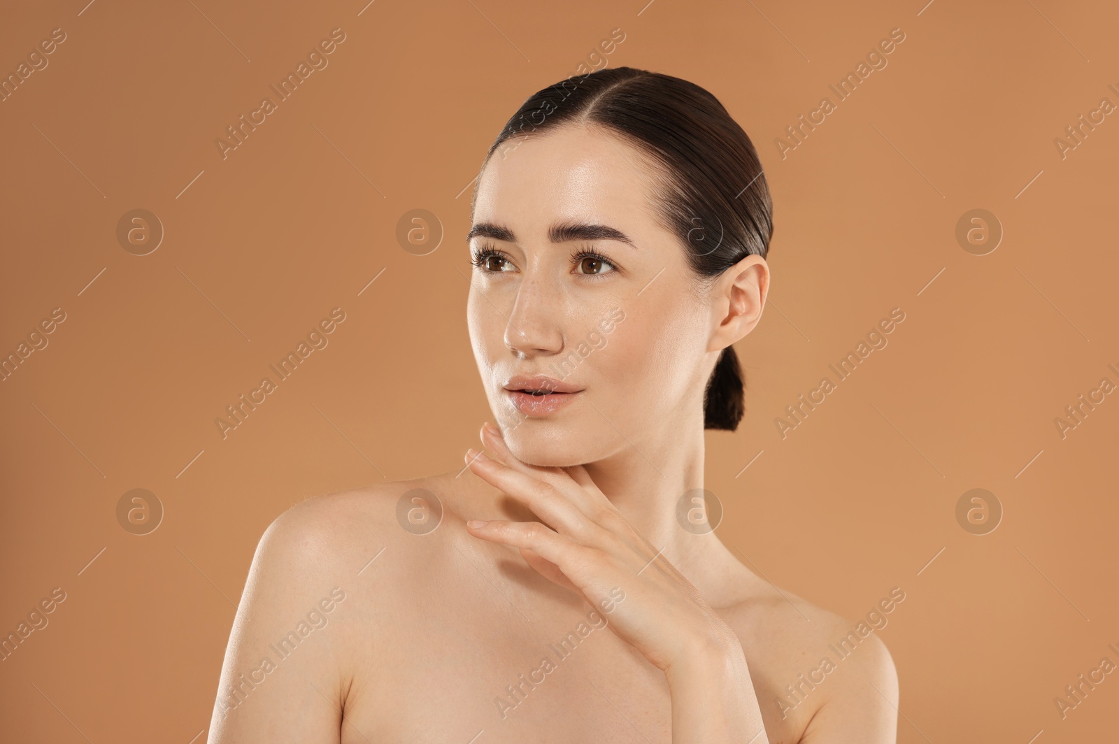 Beautiful woman after spa treatment on beige background Photo of Beautiful woman after spa treatment on beige background