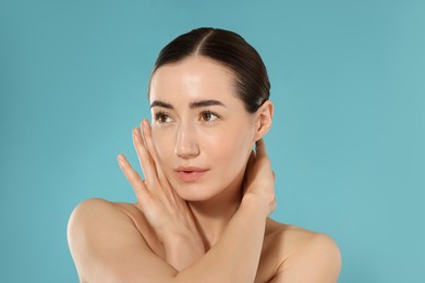 Photo of Beautiful woman after spa treatment on light blue background