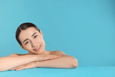 Photo of Smiling woman after spa treatment on light blue background. Space for text