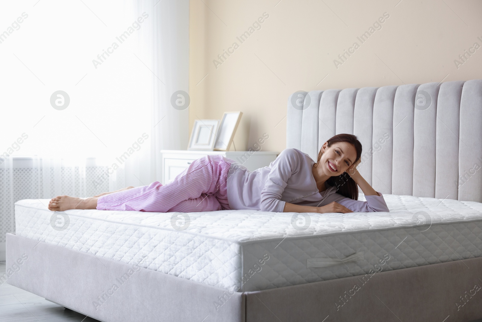 Woman lying on bed with orthopedic mattress at home Photo of Woman lying on bed with orthopedic mattress at home
