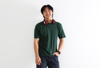 Photo of Smiling Asian man with headphones on white background