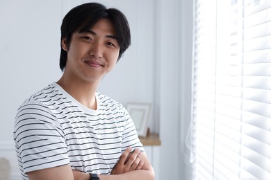 Photo of Portrait of handsome man at home. Space for text