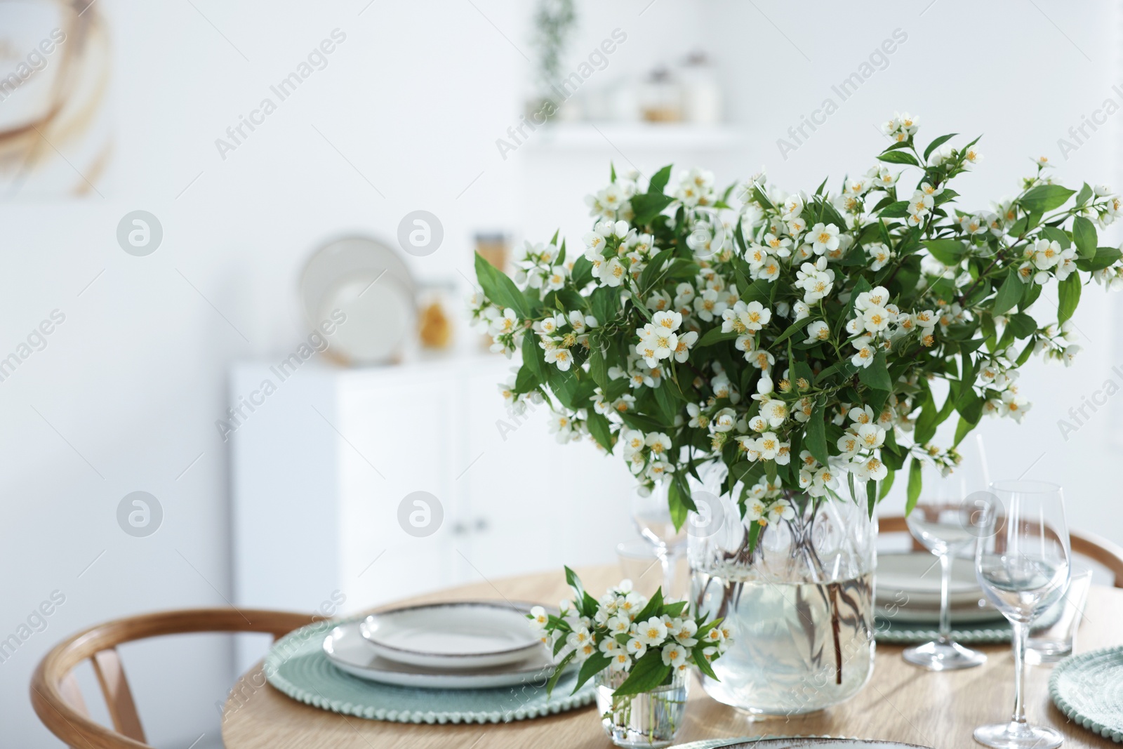 Bouquet of beautiful jasmine flowers on dining table indoors. Space for text Photo of Bouquet of beautiful jasmine flowers on dining table indoors. Space for text