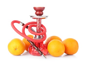 Photo of Red traditional hookah and oranges isolated on white