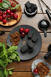 Photo of Flat lay composition with traditional hookah parts on wooden table