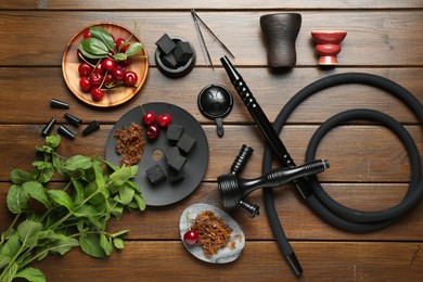 Photo of Flat lay composition with traditional hookah parts on wooden table