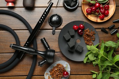 Photo of Flat lay composition with traditional hookah parts on wooden table