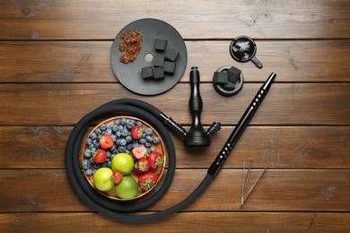 Photo of Flat lay composition with traditional hookah parts on wooden table