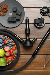 Photo of Flat lay composition with traditional hookah parts on wooden table