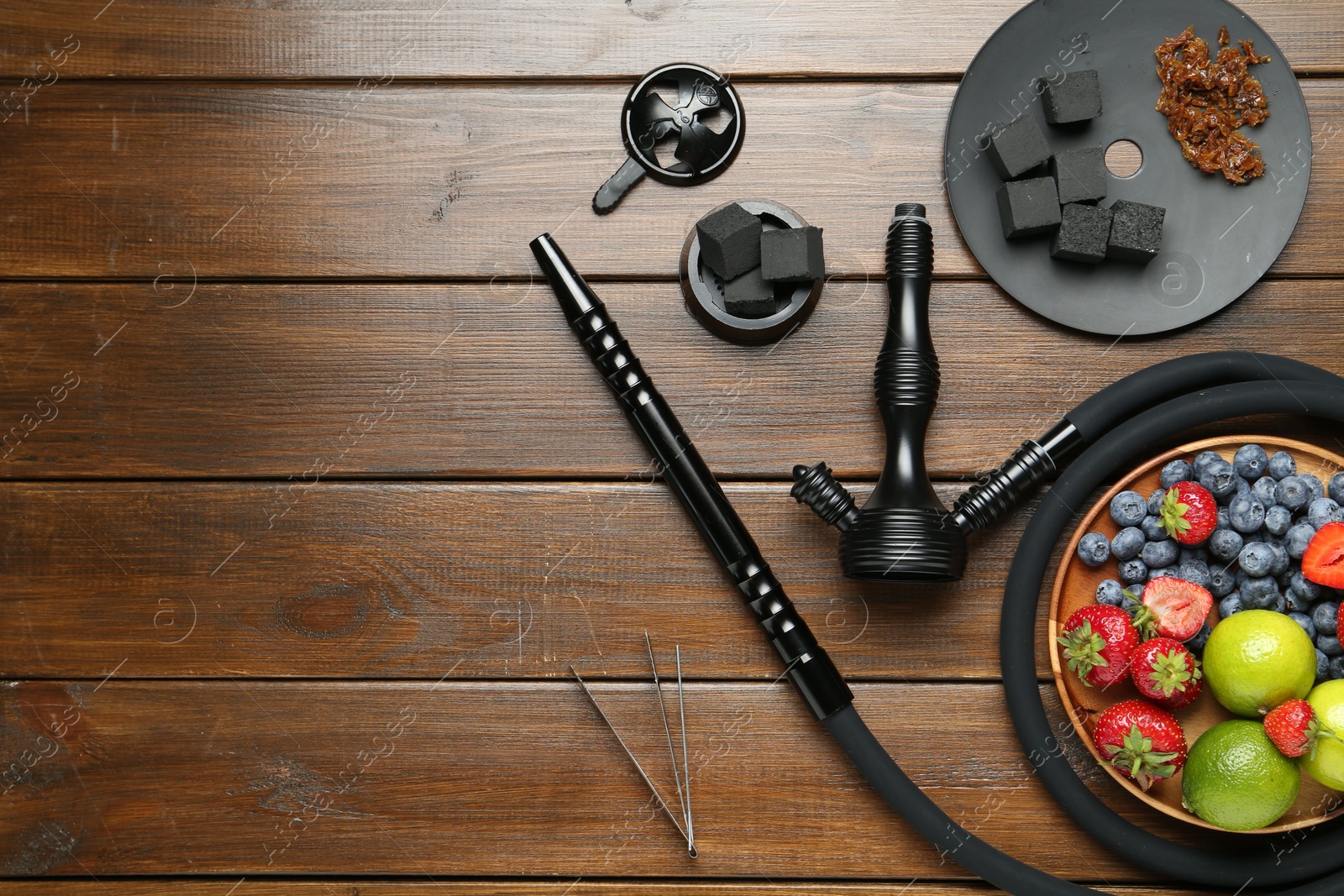 Photo of Flat lay composition with traditional hookah parts on wooden table, space for text