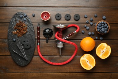 Photo of Flat lay composition with traditional hookah parts on wooden table