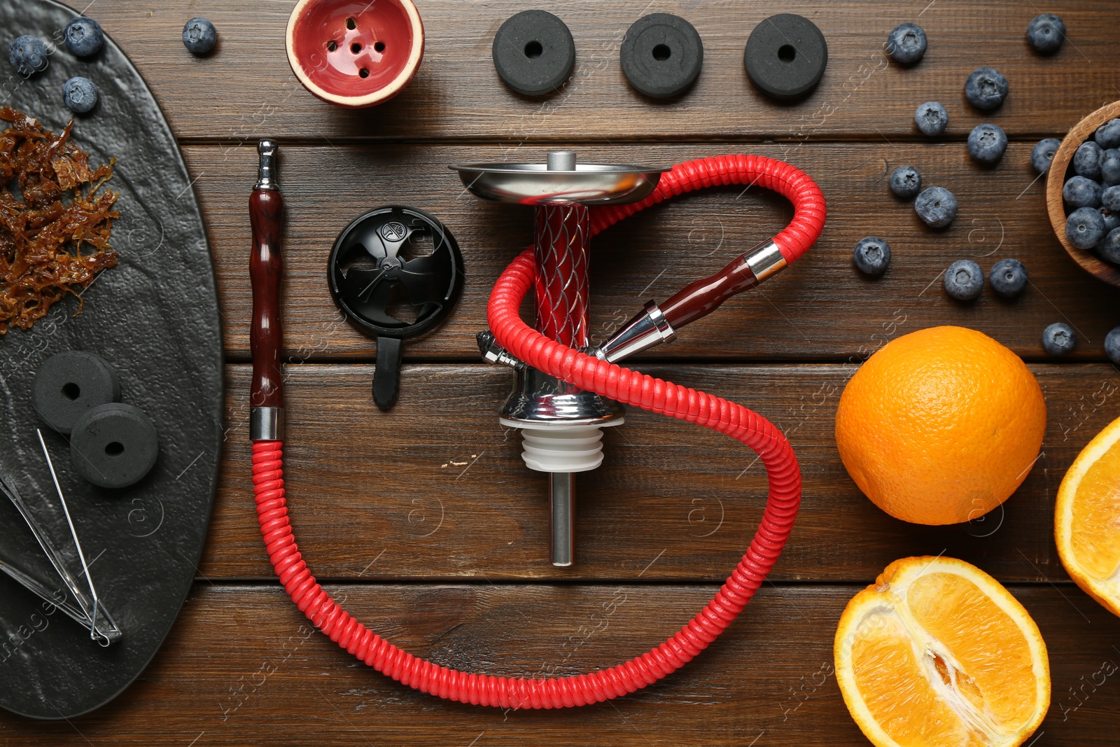 Photo of Flat lay composition with traditional hookah parts on wooden table