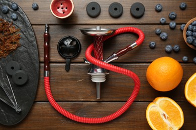 Photo of Flat lay composition with traditional hookah parts on wooden table