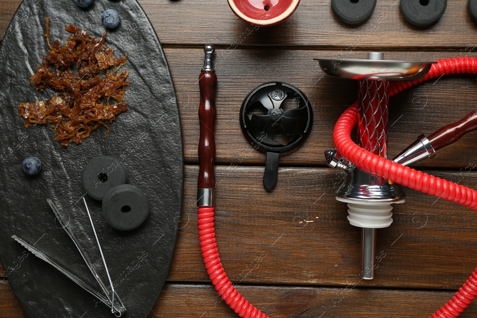 Photo of Flat lay composition with traditional hookah parts on wooden table
