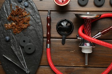 Photo of Flat lay composition with traditional hookah parts on wooden table