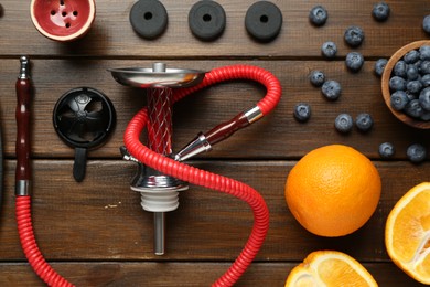 Photo of Flat lay composition with traditional hookah parts on wooden table