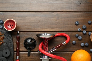 Photo of Flat lay composition with traditional hookah parts on wooden table, space for text