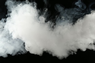 Photo of Beautiful hookah smoke on black background, closeup
