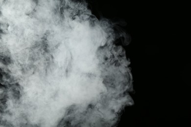 Photo of Beautiful hookah smoke on black background, closeup