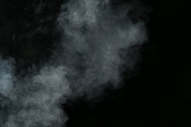 Photo of Beautiful hookah smoke on black background, closeup