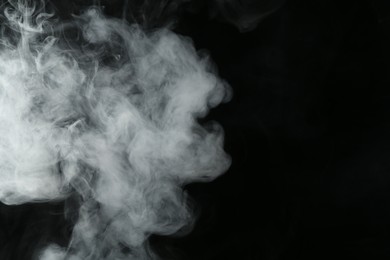 Photo of Hookah smoke on black background, closeup. Space for text