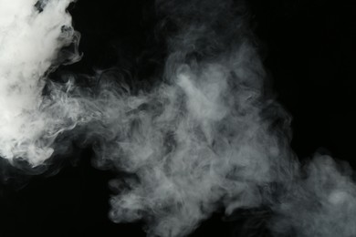 Photo of Beautiful hookah smoke on black background, closeup