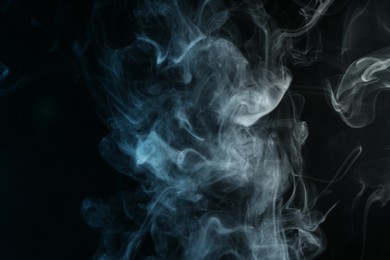 Photo of Beautiful hookah smoke on black background, closeup