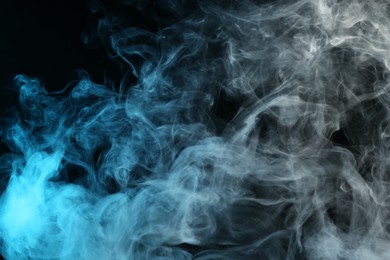 Photo of Beautiful hookah smoke on black background, closeup