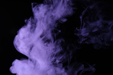 Photo of Hookah smoke in violet light on black background, closeup