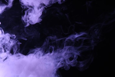 Photo of Hookah smoke in violet light on black background, closeup