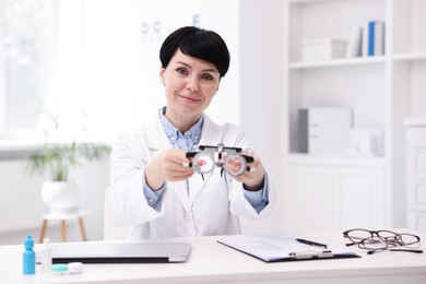 Photo of Portrait of professional ophthalmologist at white table in clinic
