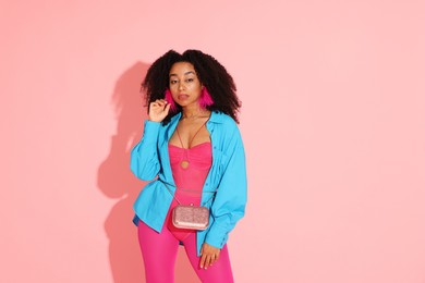 Photo of Fashionable portrait of beautiful Brazilian woman in stylish outfit on pink background. Space for text