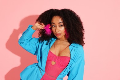 Photo of Fashionable portrait of beautiful Brazilian woman in stylish outfit on pink background
