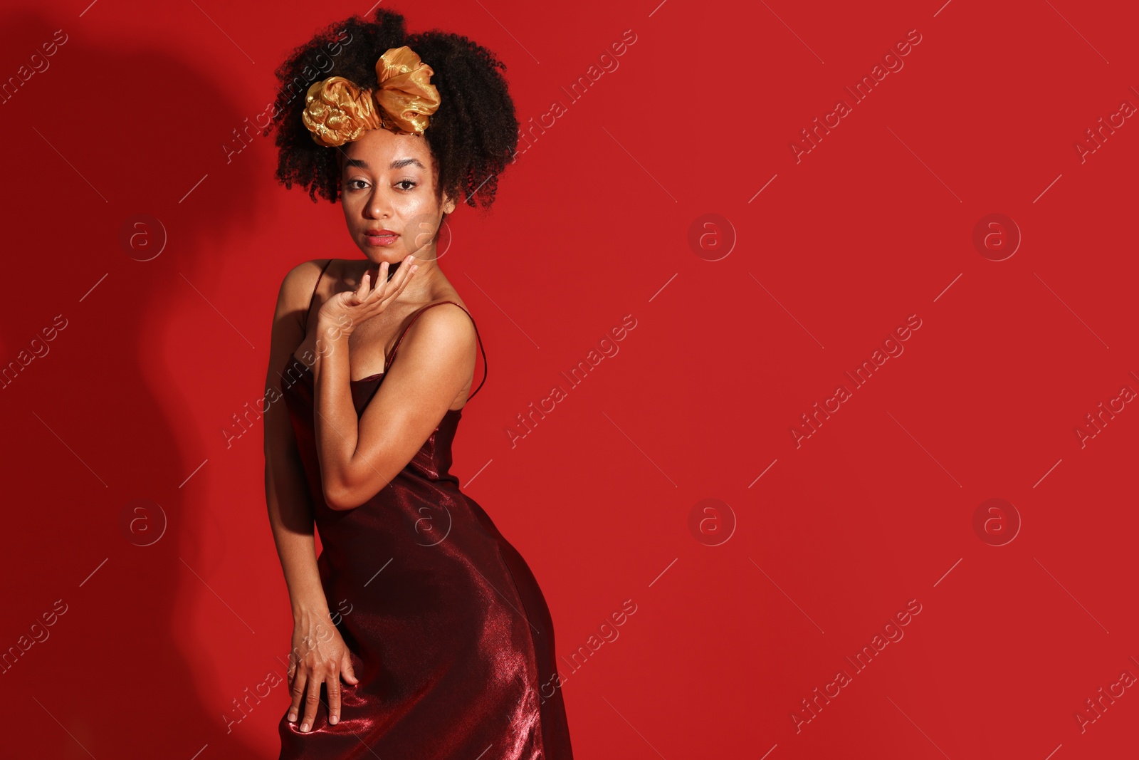 Fashionable portrait of beautiful Brazilian woman in stylish outfit on red background. Space for text Photo of Fashionable portrait of beautiful Brazilian woman in stylish outfit on red background. Space for text