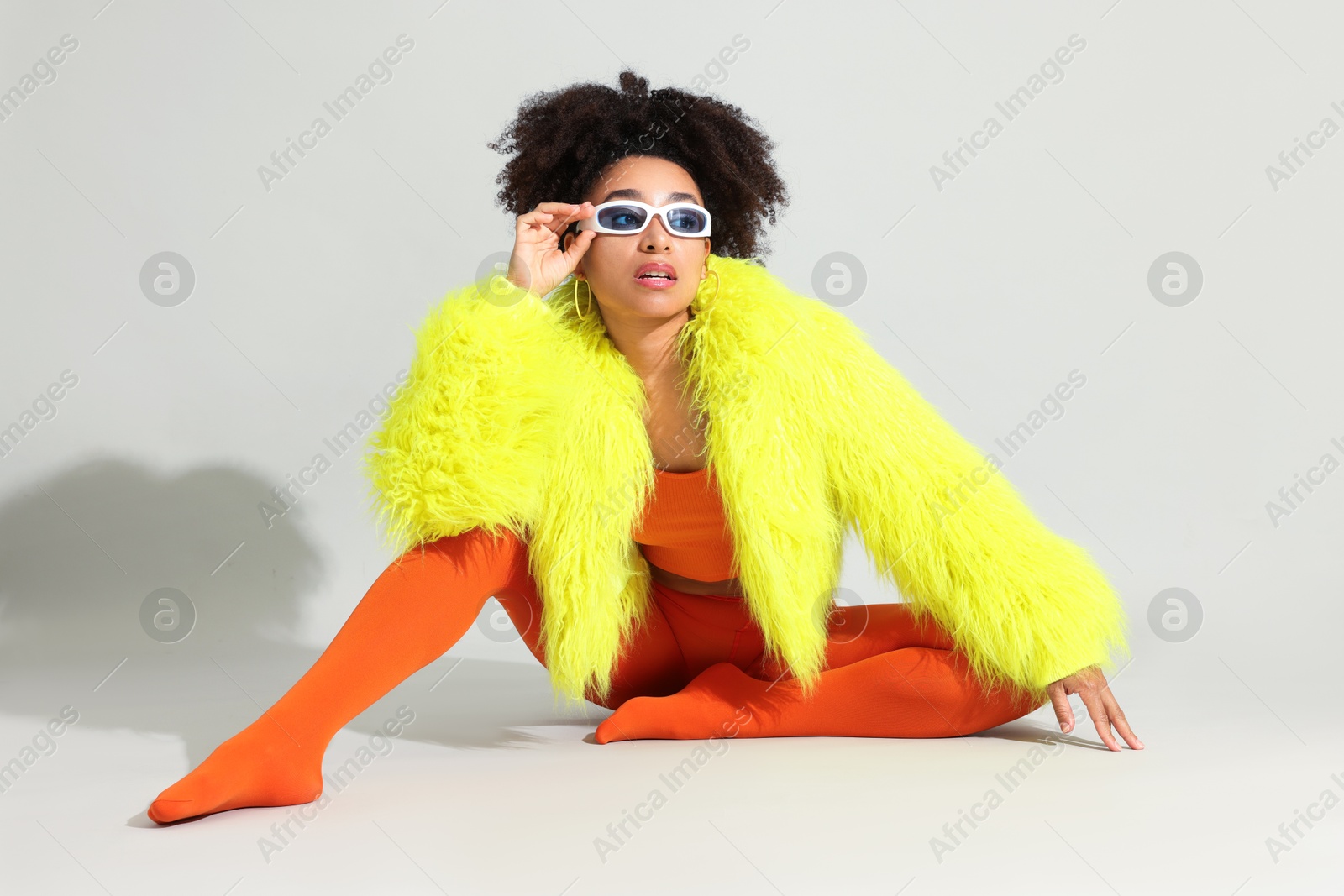 Fashionable portrait of beautiful Brazilian woman in stylish outfit on white background Photo of Fashionable portrait of beautiful Brazilian woman in stylish outfit on white background