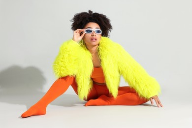 Photo of Fashionable portrait of beautiful Brazilian woman in stylish outfit on white background