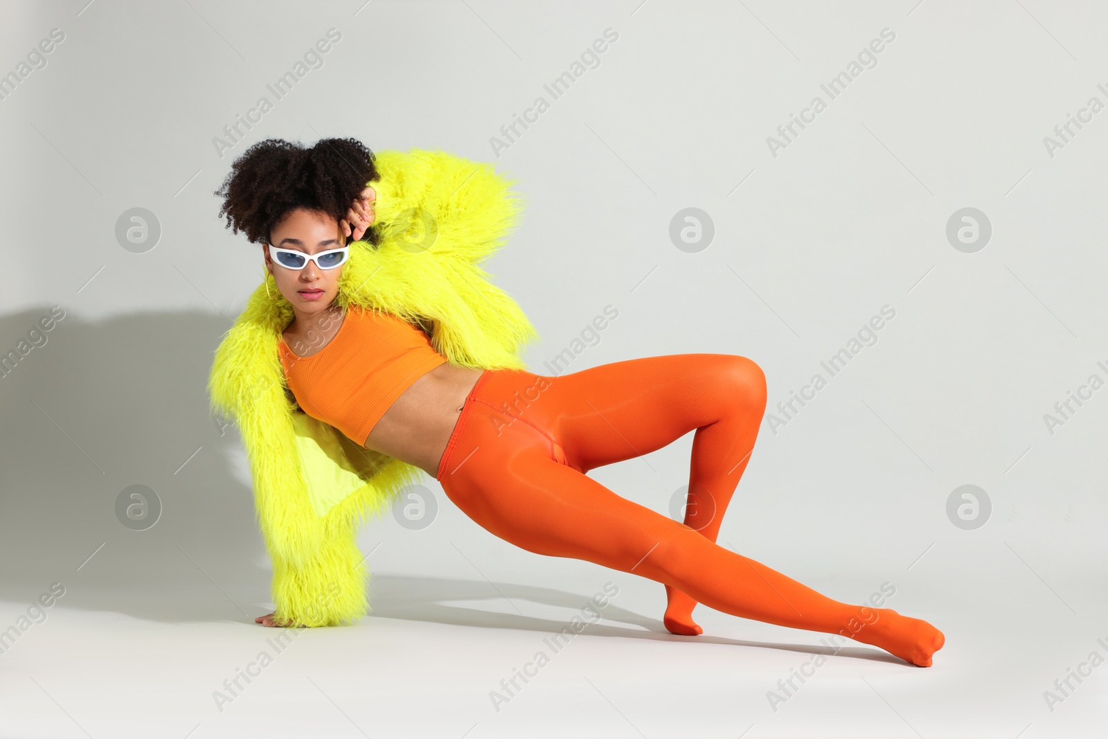 Fashionable portrait of beautiful Brazilian woman in stylish outfit on white background Photo of Fashionable portrait of beautiful Brazilian woman in stylish outfit on white background