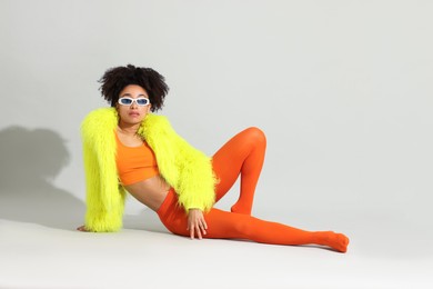 Photo of Fashionable portrait of beautiful Brazilian woman in stylish outfit on white background