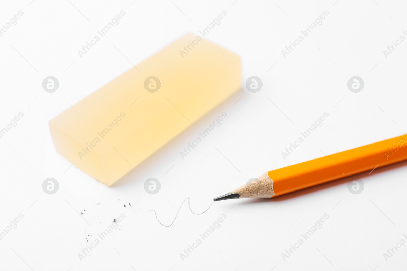 Photo of Pencil and eraser on white background, closeup