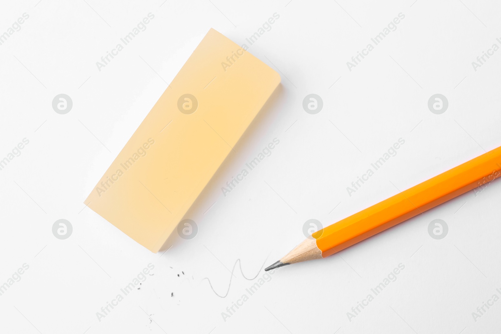Pencil and eraser on white background, flat lay Photo of Pencil and eraser on white background, flat lay